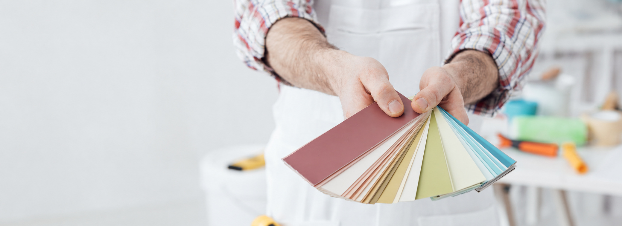 Painter presenting a fan of paint color swatches
